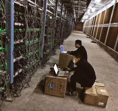 A high-density mining farm with rows of mining rigs